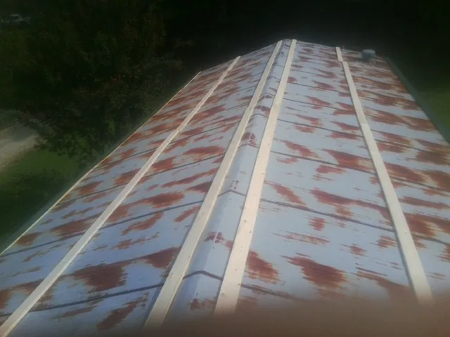Rusted metal roof panels with new wood purlins before replacement — Storm Damage Roof Repair in Priest River by Roofing Brothers